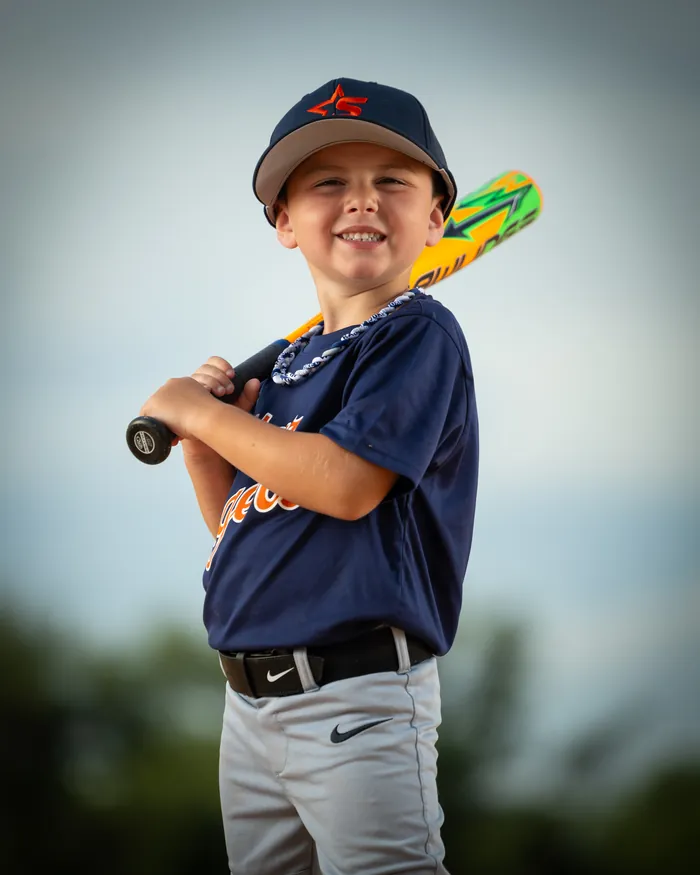 Star Tigers tee ball player smiling with a bat on his shoulder, Star Idaho