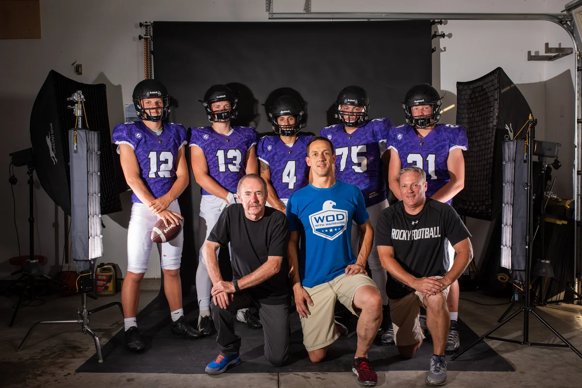 Mark Rezansoff and Coach Chris Culig with Rocky Mountain High School football players during the first garage portrait session in Meridian Idaho 2018 — the shoot that started Shooting Trio Photography