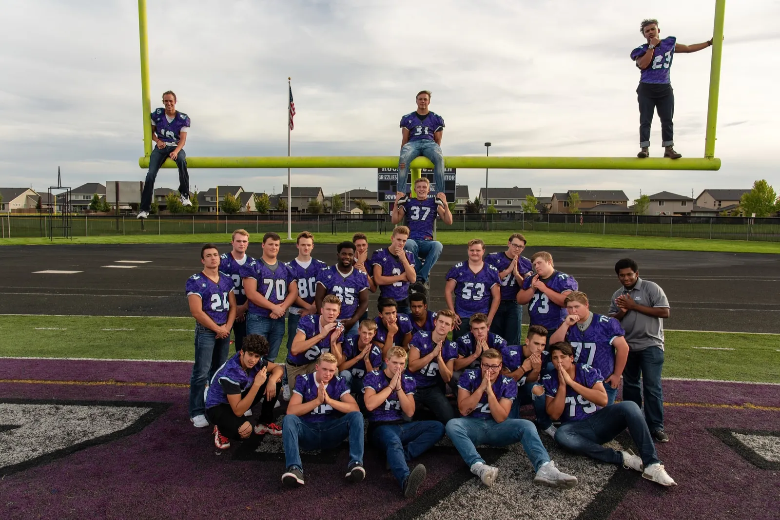 Rocky Mountain High School football seniors posed on and around the goalposts, Meridian Idaho, September 2018 — one of the first teams Shooting Trio Photography ever photographed