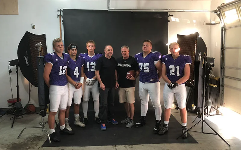 Mark Rezansoff and Rocky Mountain High School football players during the first garage portrait session in Meridian Idaho 2018 — the origin of Shooting Trio Photography