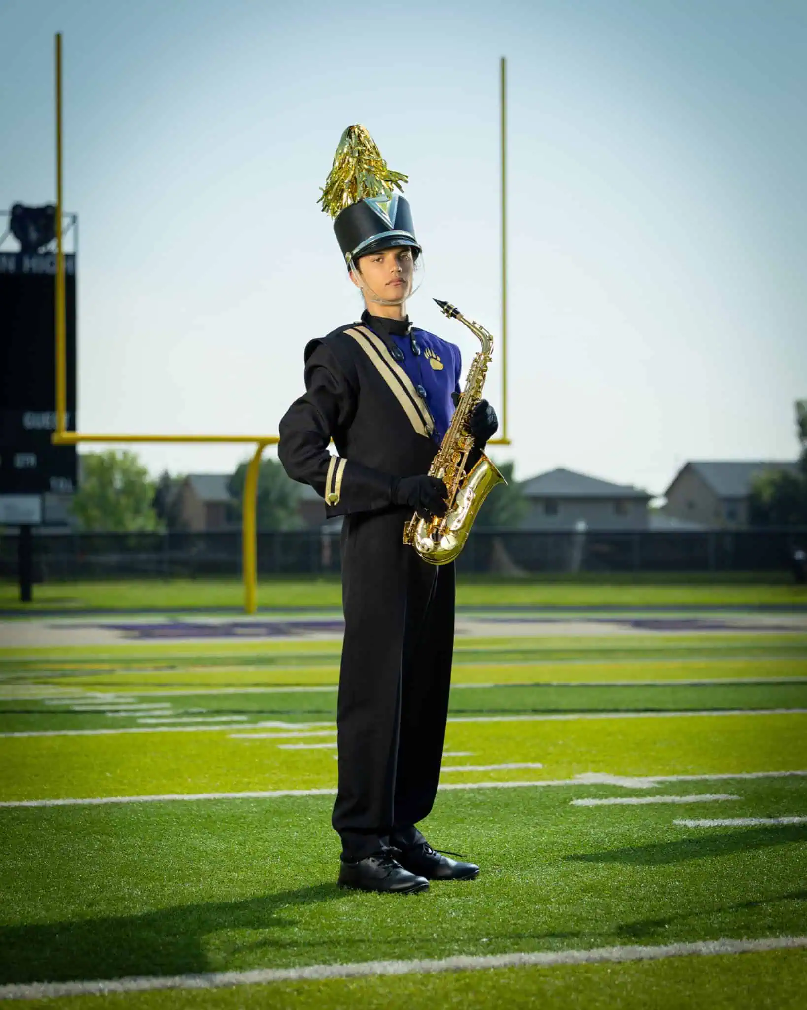 High school band member senior portrait with alto saxophone in dress uniform