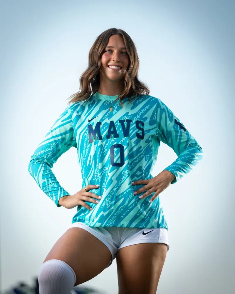 Addyson Crumley #0 from a low angle, one knee raised and her hands on her hips