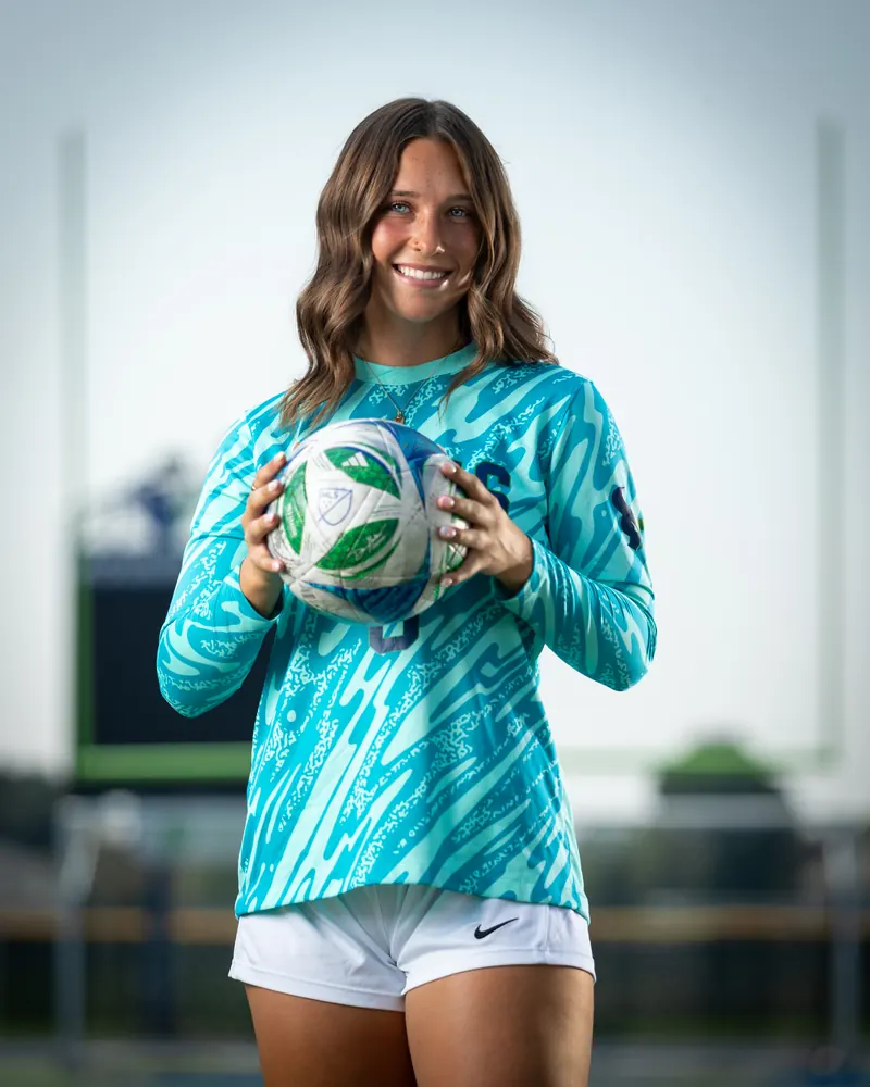 Addyson Crumley #0 waist up, holding the ball at her chest
