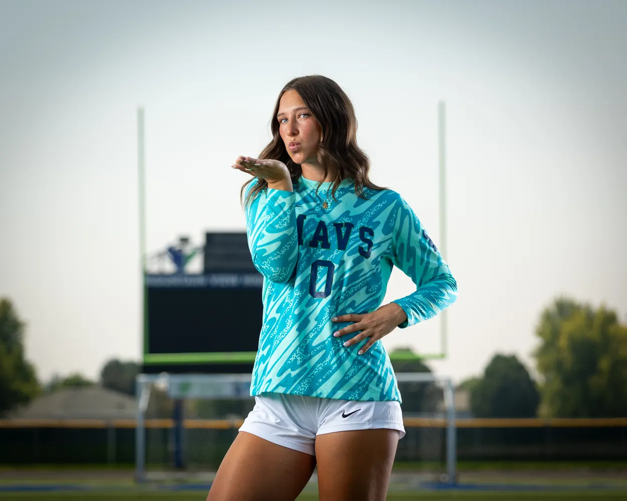 Horizontal frame of Addyson Crumley #0 from the thighs up, blowing a kiss