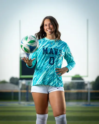 Addyson Crumley #0 from the knees up in her teal keeper jersey, tossing the ball from an open hand