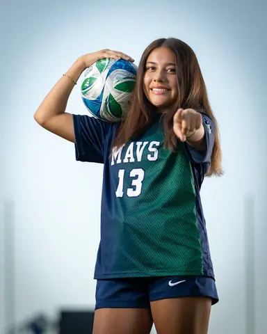 Alexa Martinez #13 holding the ball on her shoulder and pointing at the camera