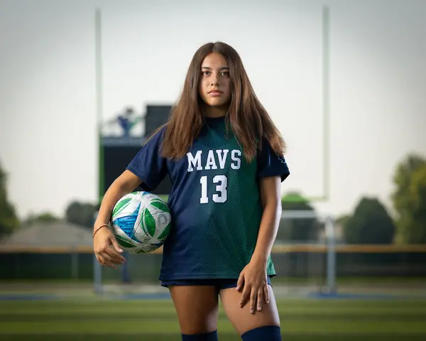 Alexa Martinez #13 with a serious look, holding the ball at her hip