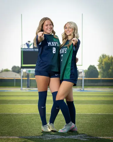 Allie Louvier #8 and Jaci Anderson #7 side by side, both pointing at the camera