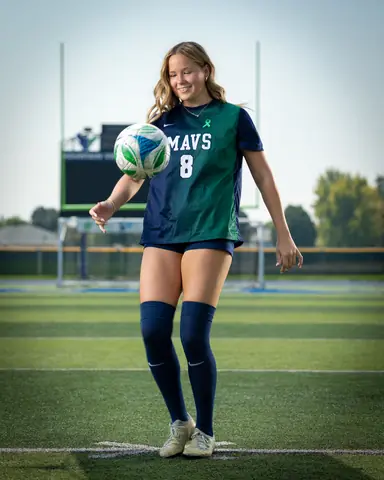 Allie Louvier #8 full length, juggling the ball in front of her chest