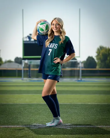 Jaci Anderson #7 full length with the ball on her shoulder under the goalposts