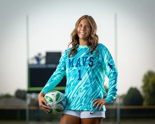 Laney Otero #1 in her keeper jersey, smiling with the ball at her hip
