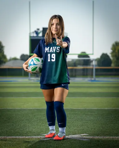 Maria Rojas #19 full length, ball on her hip, throwing a rock-on hand sign
