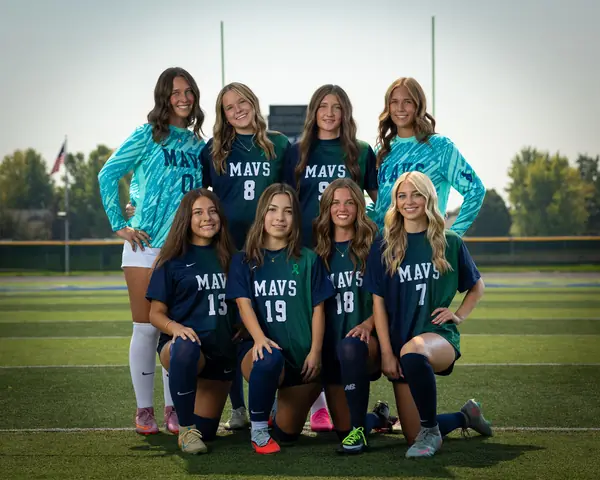 All eight Mountain View girls soccer seniors posed in two rows on the field, the two keepers in teal at the back