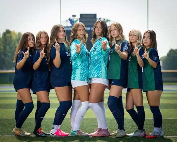 The eight Mountain View girls soccer seniors full length, throwing the horns hand sign