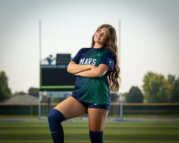 Vivian Sipe #9 with arms crossed and head tilted, one knee raised