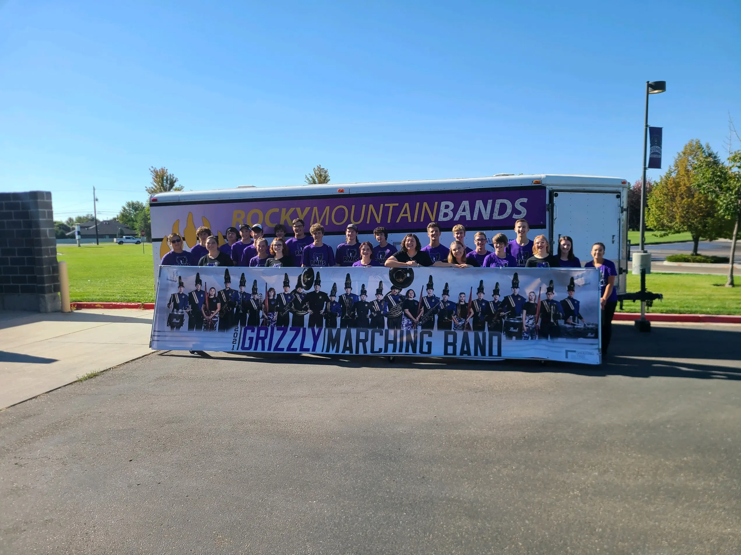 Rocky Mountain High School marching band seniors gathered behind their custom banner after the Class of 2022 portrait session in Meridian Idaho