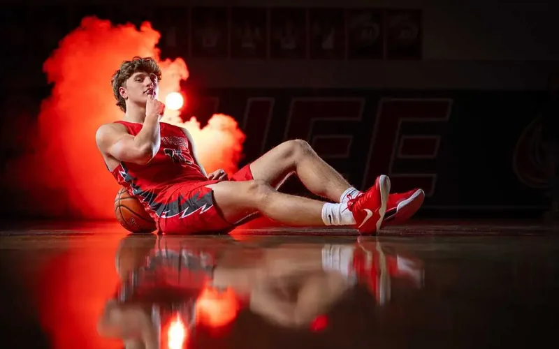 Owyhee basketball players at a media day photo session with red smoke and studio lighting