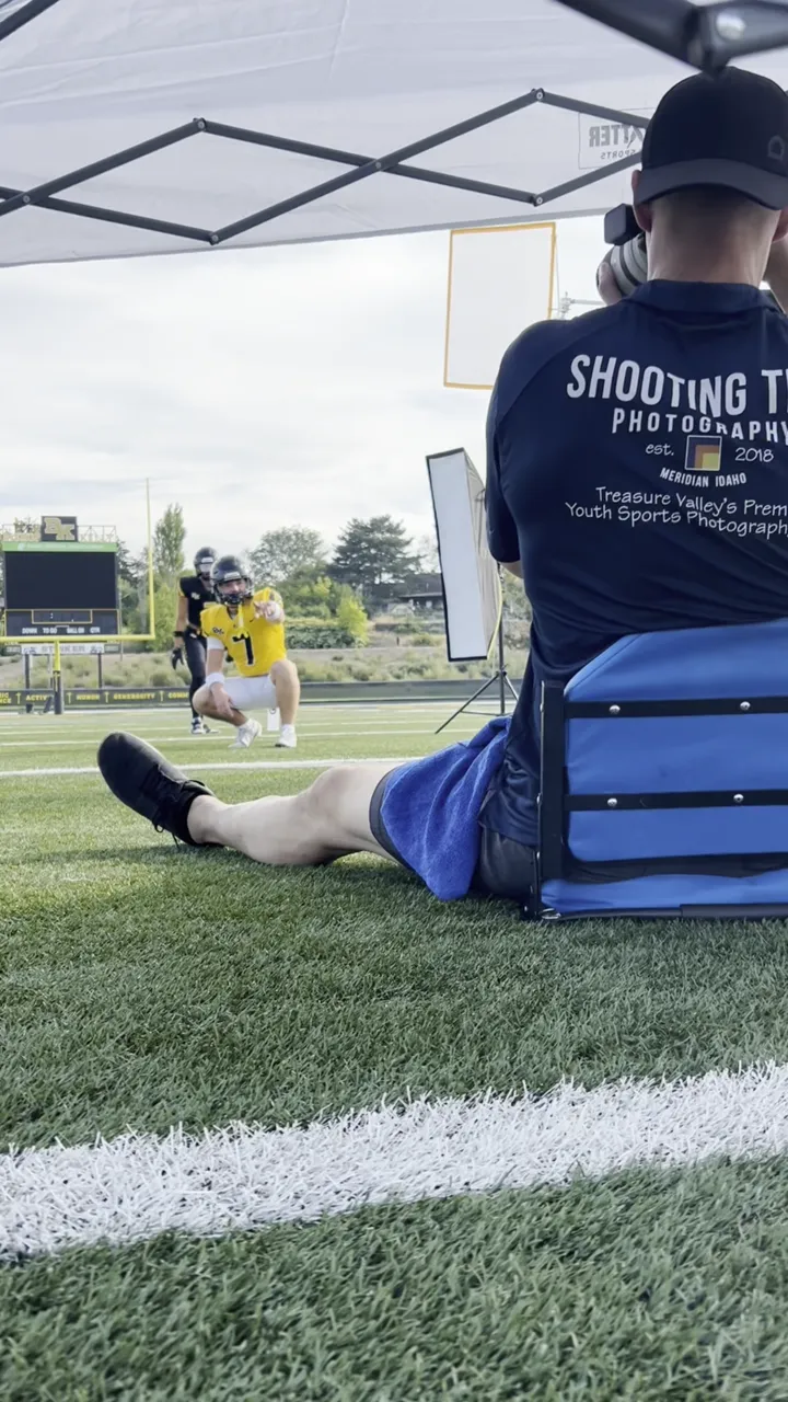 Shooting Trio photographer working on the field at a Bishop Kelly football media day