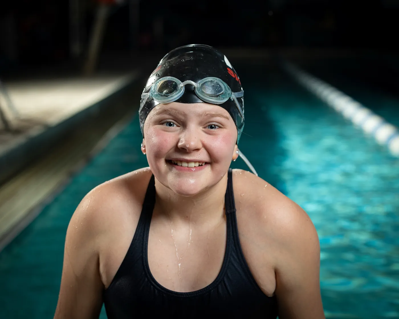 Nampa swim team swimmer in cap and goggles poolside portrait Nampa Idaho