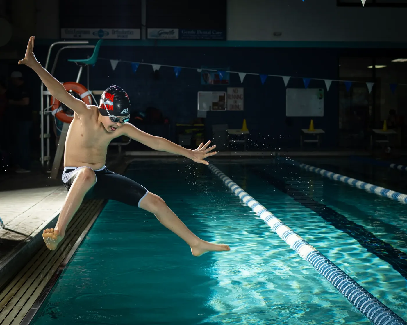 Nampa swim team swimmer jumping into the pool Nampa Idaho