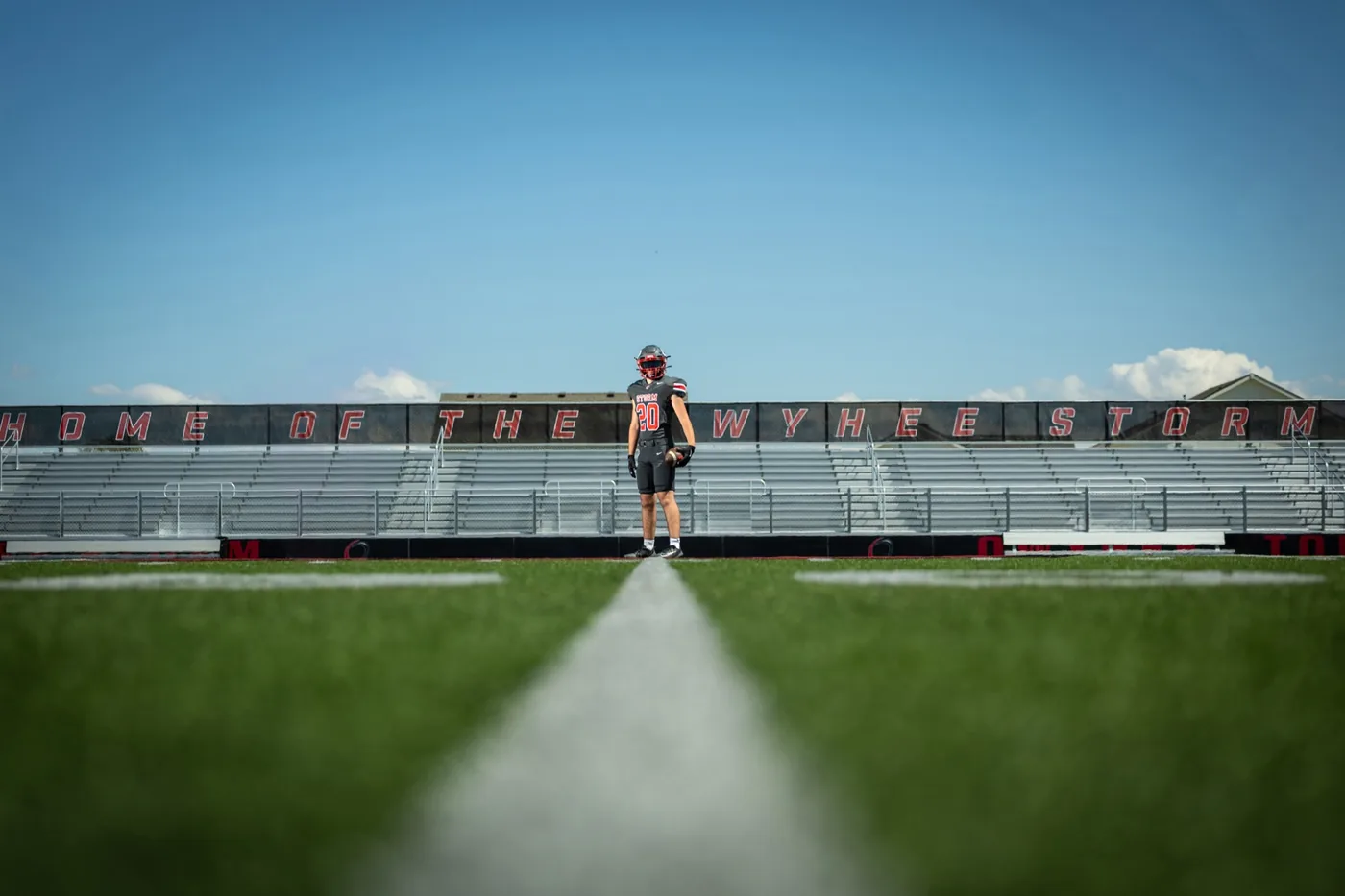 Owyhee High School senior football portrait on the home field below the Home of the Owyhee Storm sign Meridian Idaho