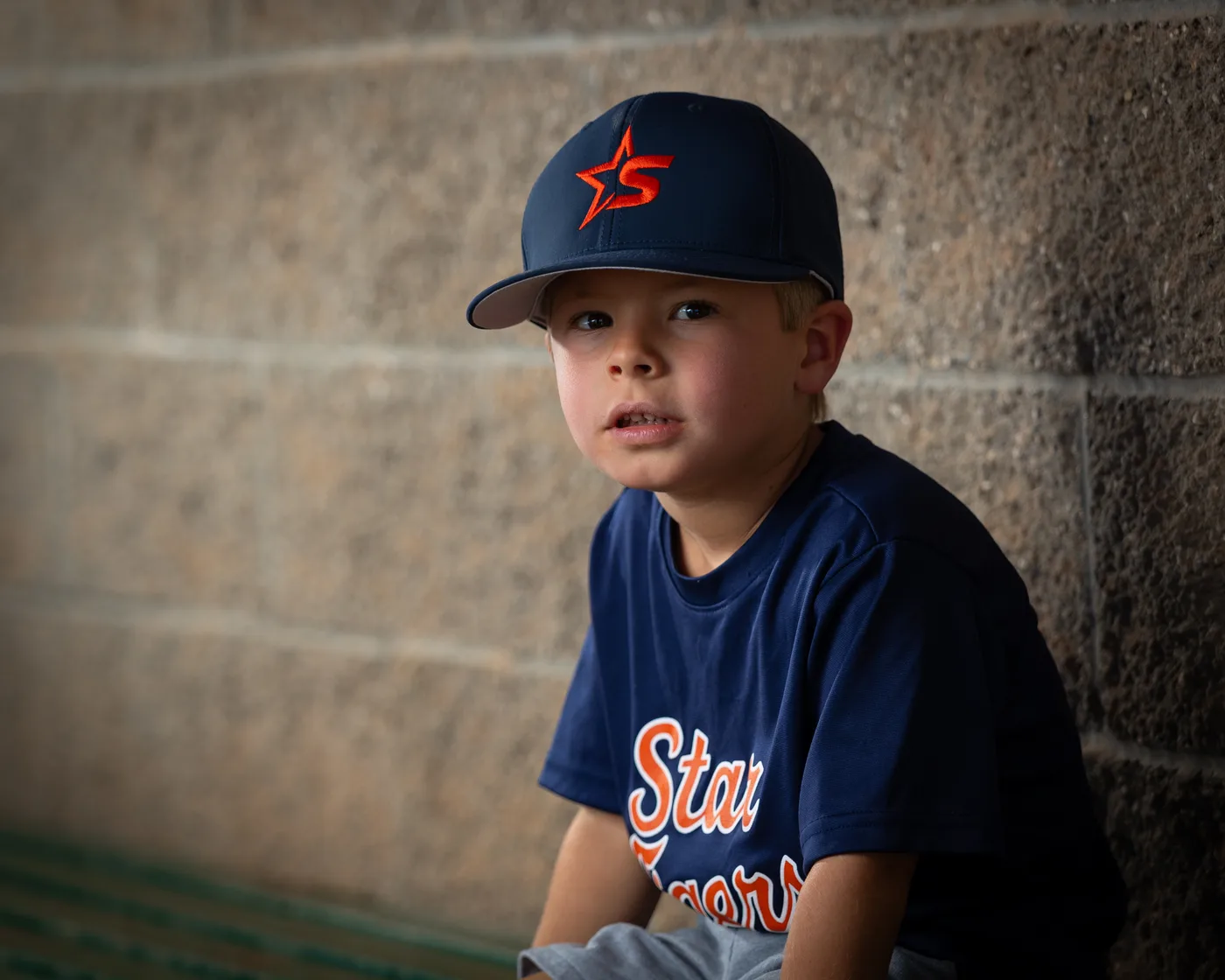 Star Tigers youth baseball player in the dugout in natural light, Star Idaho