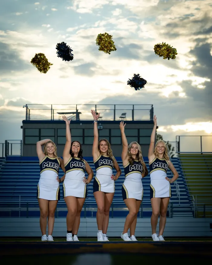 Middleton High School cheerleaders tossing their poms in the stadium, Middleton Idaho