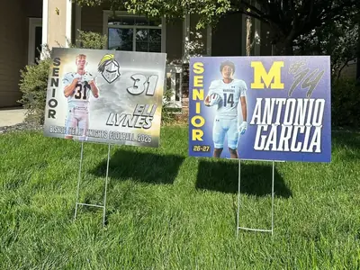 Bishop Kelly and Meridian senior football yard signs in a front lawn